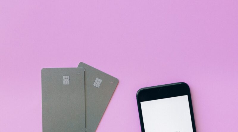 Credit Cards and a Smartphone on a Pink Surface