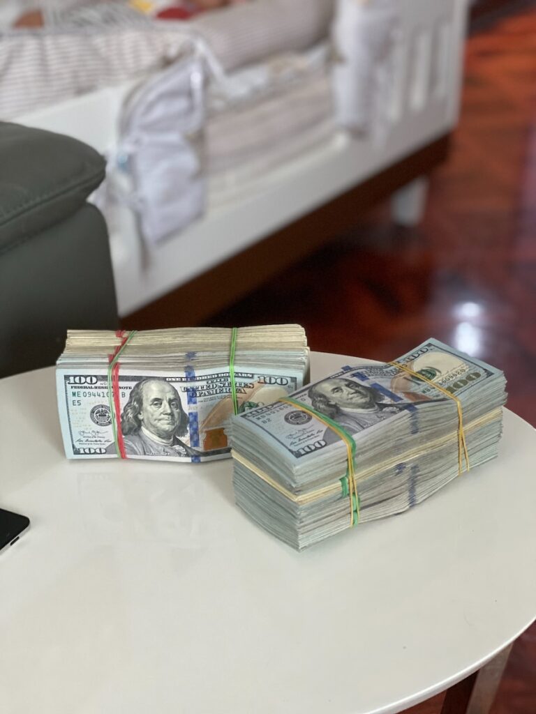 a stack of money sitting on top of a white table