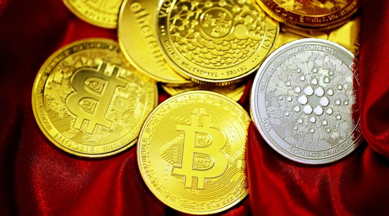 a pile of bitcoins sitting on top of a red cloth